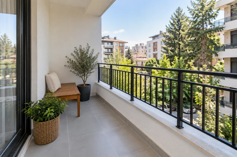 Seramik zemin, oturma bankı ve bitkilerle düzenlenen balkon.